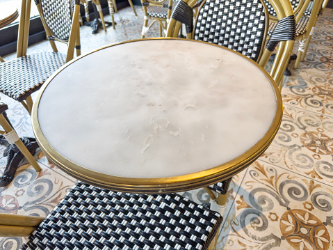 Chic marble cafe table and chairs with chic mosaic tiled floor