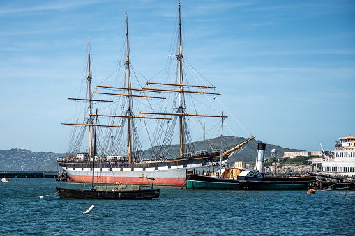 Big old  wooden sailing ship and old steamship in San Francisco Bay during springtime day