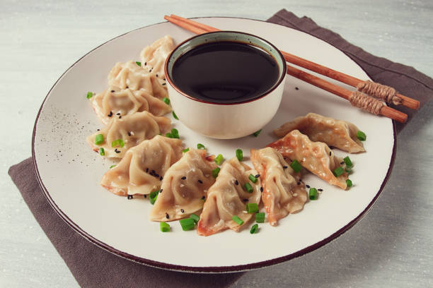 istock Japanese Gyoza dumplings,fried, with sauce, top view, without people, tinted, selective focus, 2149407606