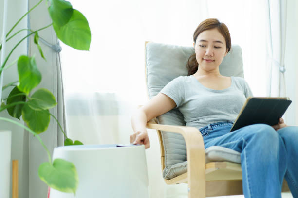 istock Asian woman using air purifier during living at home. 2149408683