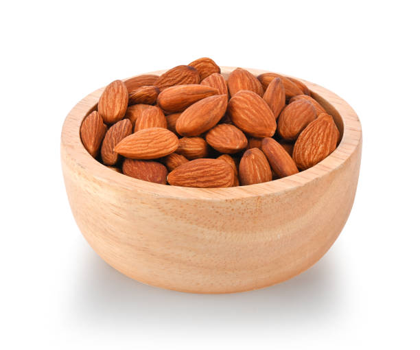 istock Almonds in wood bowl isolated on white background. 2149409425