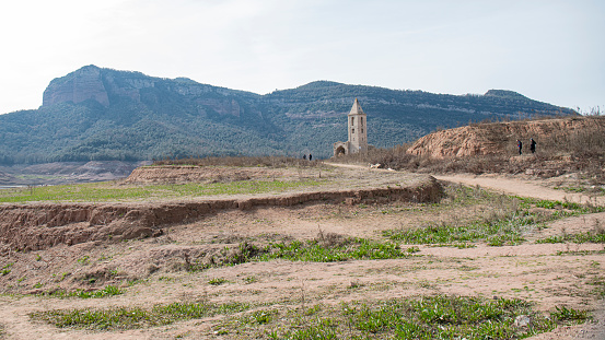 The impact of the ongoing drought on the Sau Reservoir in Catalunya.\nThe bell tower of the old, abandoned village of Sant Romà, located in central Catalonia's Sau reservoir. Spain