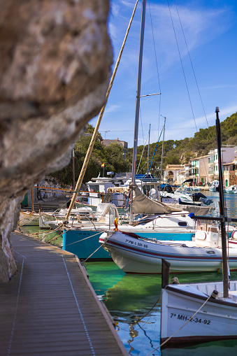 Cala Figuera, Spain -April 20, 2024: Scenic overview of small boats in Cala Figuera’s fishing harbor, nestled in a charming bay, a popular tourist destination on Mallorca's southeast coast.