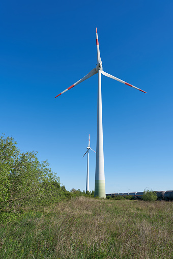 two wind turbines to generate electricity in a landscape in the north of the city of Magdeburg in Germany