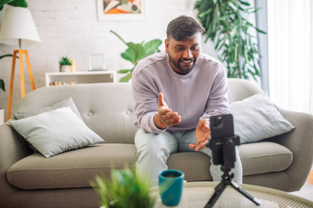 istock Young indian man recording a vlog at home 2149413081