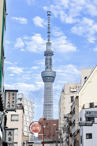 Tokyo, Japan - October 13, 2023: A view of  Tokyo Skytree from  Nakamise shopping street in the Asakusa district of Tokyo, Japan on a blue sky day.