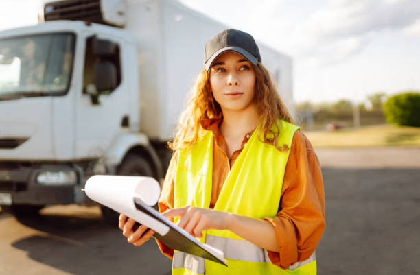istock Young woman professional driver checking shipment list on a -parking lot. 2149413499