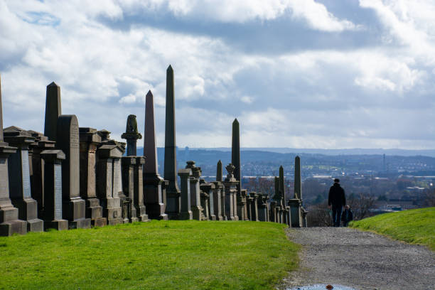 Glasgow, Scotland, UK, 2024:  A row of monuments lines a pathway at the top of the Glasgow Necropolis.