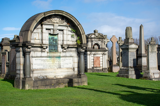 Glasgow, Scotland, UK, 2024:  The Walter MacFarlane mausoleum includes a copper relief at the Glasgow Necropolis.