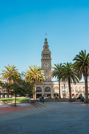 San Francisco, California, April 8, 2024. Clear skies over the Ferry Building in San Francisco, with people enjoying the plaza.