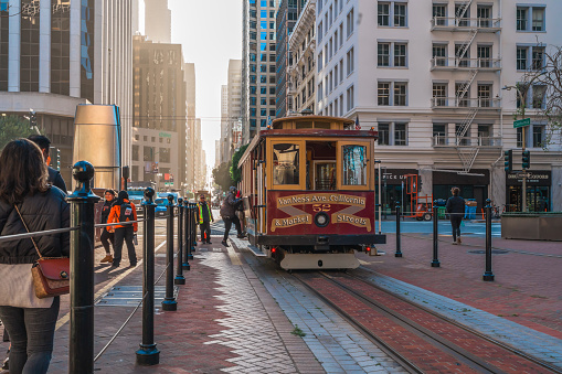 San Francisco, California, April 8, 2024. Historic cable car travels down a bustling San Francisco street.