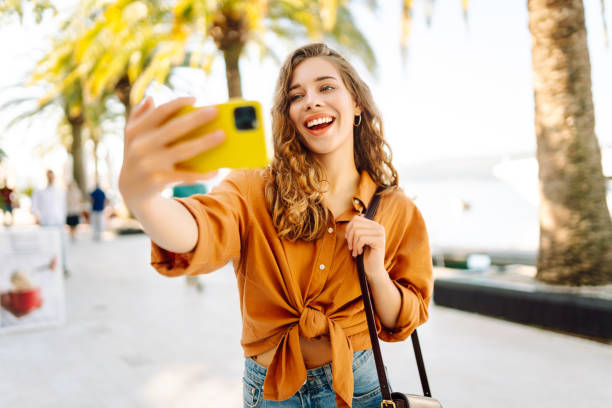 istock A tourist walks the streets and takes selfie using smartphone camera. 2149417160