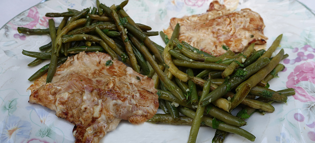 Veal chops cooked in cream served with boiled green beans then browned