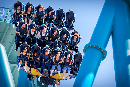 San Diego, California, USA - October 3, 2024: Riders on a roller coaster at a sudden drop at Sea World.