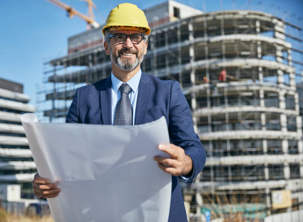 istock senior businessman architect helmet construction site building architecture tablet computer protective workwear blueprint plan 2149419506
