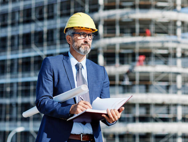 istock senior businessman architect helmet construction site building architecture tablet computer protective workwear blueprint plan 2149419747