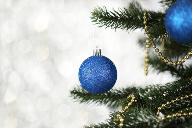 istock Christmas fir tree with ornaments on blurred lights background 2149420085
