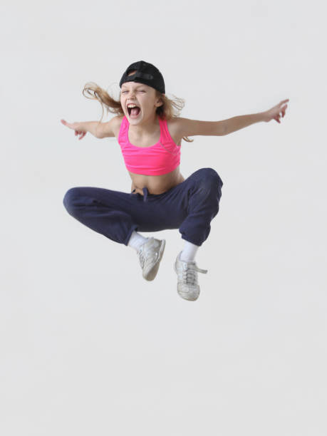 istock little girl jumping in studio 2149420523