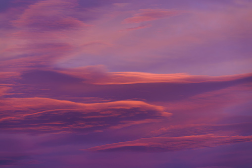 Colorful Sunset Clouds Sky Replacement - Background image with pink, orange, and red clouds lit with warm light at sunset. Interesting cloud formations with dramatic lighting.