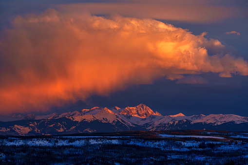 Elk Mountains with Dramatic Light - Elk Mountains near the Roaring Fork Valley including Aspen, Basalt, Carbondale and Glenwood Springs. Scenic view with dramatic orange-pink alpenglow light on peaks at sunset.