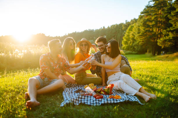 istock Group of young people having fun while drinking beer at picnic party. 2149421659