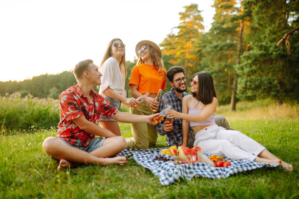 istock Group of young people having fun while drinking beer at picnic party. 2149421694
