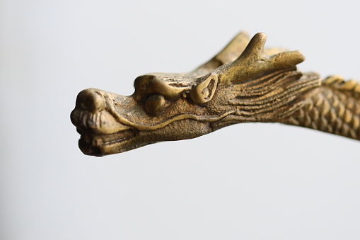 Detailed view of a dragon statue, perfect for fantasy or mythology themes.