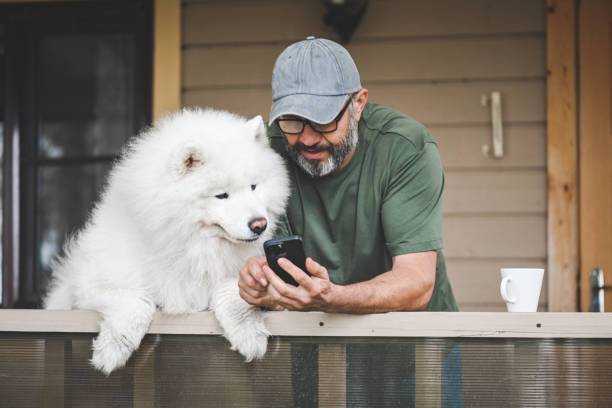 istock mature adult man with samoyed dog 2149423047