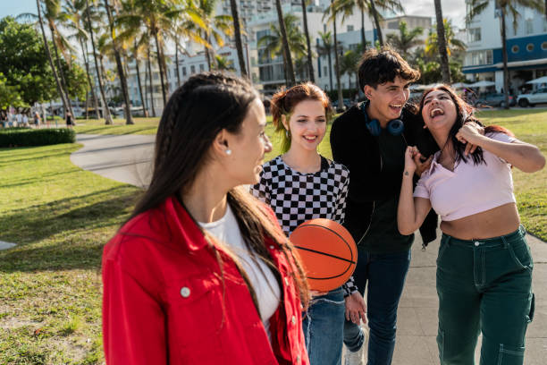 istock Friends talking and walking through the public park 2149423050