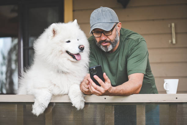 istock mature adult man with samoyed dog 2149423097