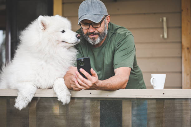 istock mature adult man with samoyed dog 2149423175