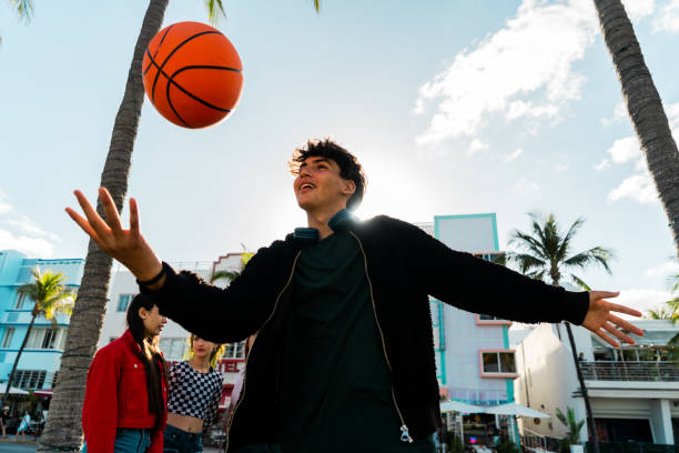 Young man playing with a basketball on public park