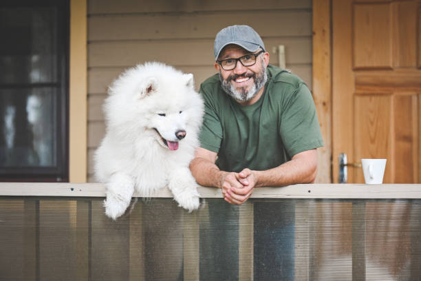 istock mature adult man with samoyed dog 2149424383