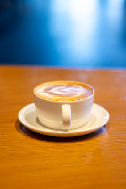 Porcelain Coffee Cup Standing On a Wooden Table