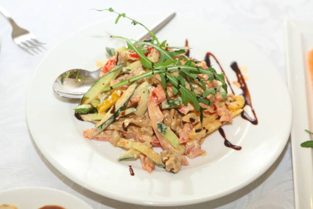 Salad with spinach and pork medallions. Useful appetizing salad of vegetables and meat. Restaurant menu. Cafe dish. Pork, avocado, spinach, sauce, sesame