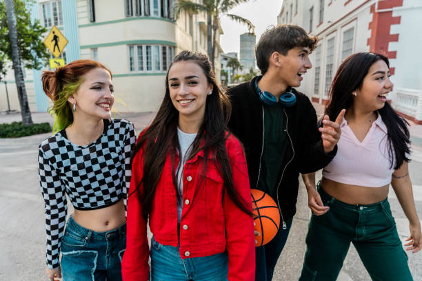 Young friends talking and walking through the city