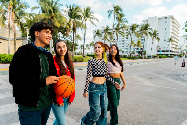 istock Young friends talking and walking through the city 2149426240