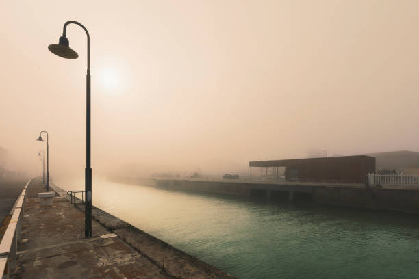 Promenade along the river by sunset, perspective view