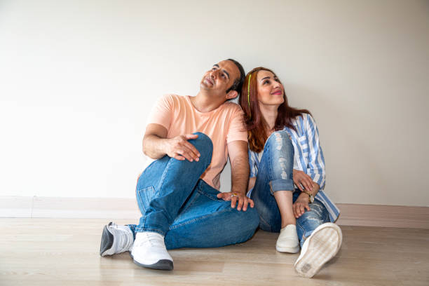istock Couple sitting on floor and dreaming future at home 2149427447