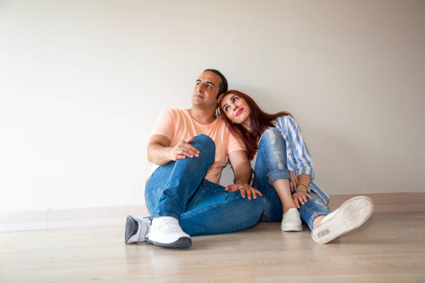 Couple sitting on floor and dreaming future at home