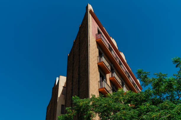 Exterior of sharply angled modern building on sky background