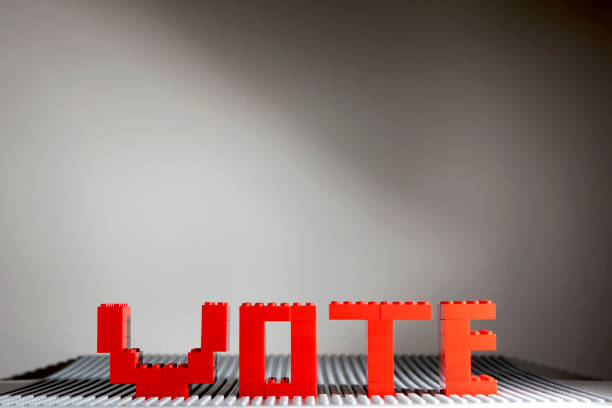 The word vote spelled out in red letters against a grey and white background,  The letters, amde from childrens building bricks, are in the colours of the British Labour Party, Predicted to win the 2024 General Election.