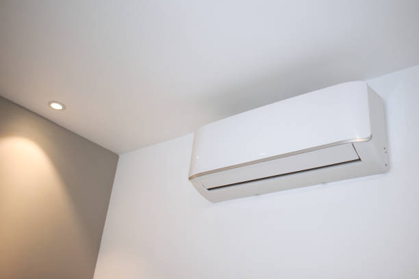 Air conditioning unit on bedroom wall stock photo
