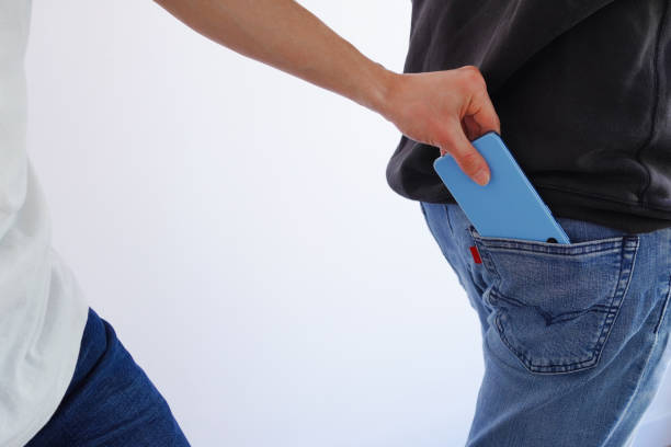 istock Pickpocket stealing  smart phone (cell phone) from a man's jeans pocket 2149432260