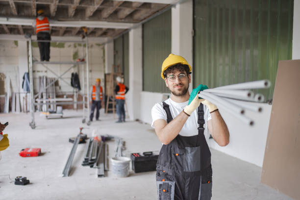 istock Male construction worker carrying pipes on shoulder 2149432435
