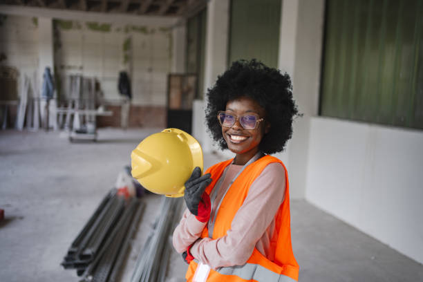 istock Smiling young Black woman in reflective clothing on construction site 2149432481