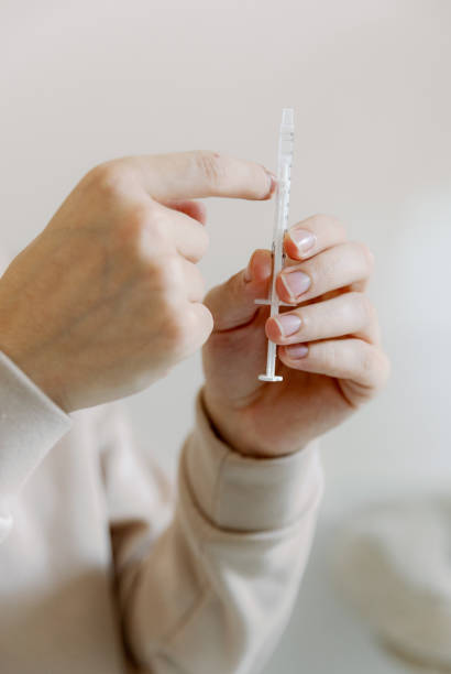 istock A young man holds a medicine in a syringe in his hands. 2149432979