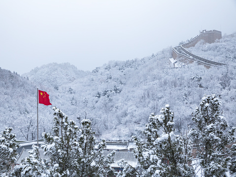 the Badaling Great Wall with snow covered forest and fog in winter, Beijing, China