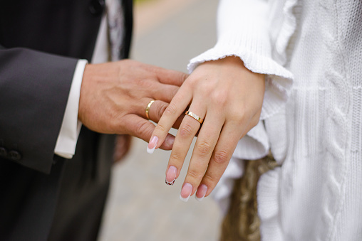 Hands of the bride and groom with wedding rings close-up