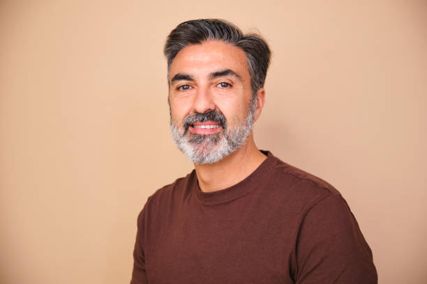 istock A man with a beard and gray hair is smiling for the camera. 2149434911